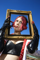 Obraz na płótnie Canvas adult female holding empty frame around face.