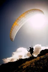  paraglider launching from the mountain ridge © Sean Nel