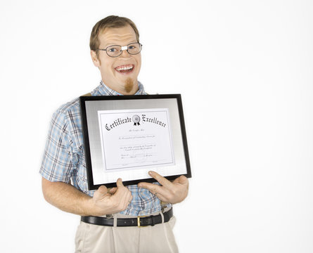 young man holding certificate and smiling.