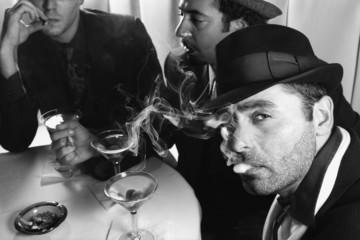 three retro businessmen drinking cocktails.
