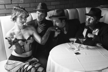 three retro businessmen wooing female.