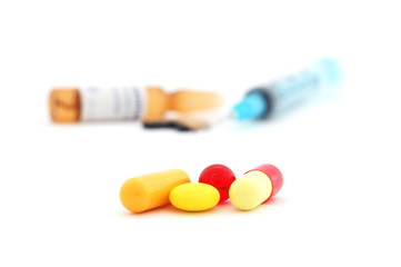 pills and medical syringe
