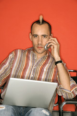 man using laptop and phone