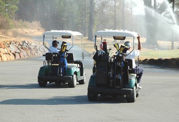 golfers with carts