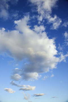 Puffy white clouds in blue sky.