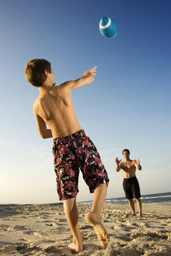 Boy Throwing Football With Dad.