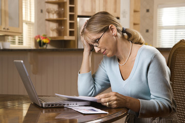 Woman paying bills on computer.