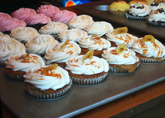 variety of gourmet cupcakes in elegant bakery