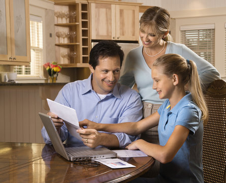 Family Paying Bills On Computer.