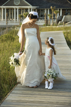Bride and flower girl walking.