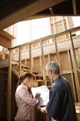 Caucasian man and woman on construction site.