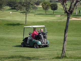 2 golfers in a golf cart