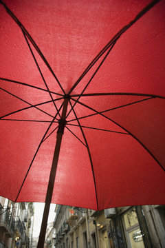 View from beneath red umbrella in Lisbon, Portugal.