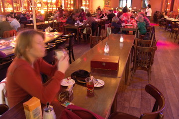 Woman drinking coffee in a grand cafe