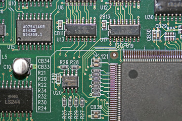 Electronic Components on Printed Circuit Board with Visible Circuit Tracks.