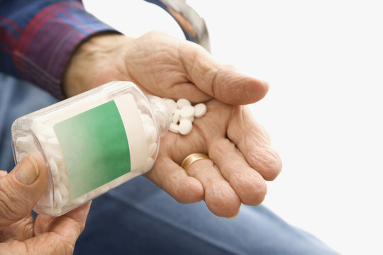 Man Pouring Pills Into Hand.