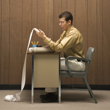 Retro Business Scene Of Man At Desk.