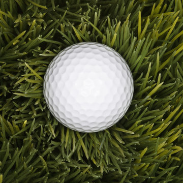 golfball laying in grass.