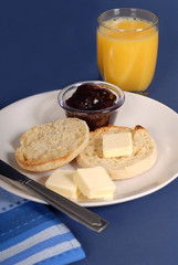 english muffin with butter, jam, juice