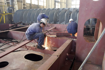 A worker is welding steel