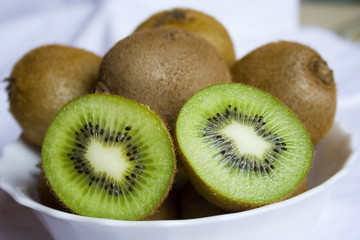 delicious green kiwis on the white plate