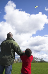 father and son flying kite together