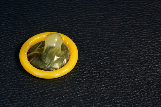 yellow condom on leather