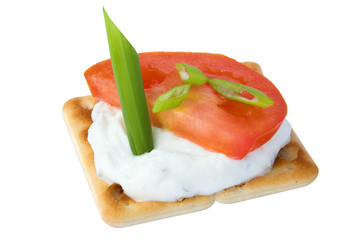 cracker with cottage cheese, tomato and garnish
