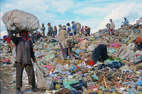 poor people working in a rubbish dump