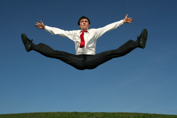 businessman doing splits in mid-air