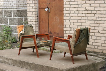 two junked armchairs