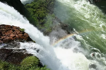 Outdoor kussens above dramatic waterfall with rainbow © SDuggan
