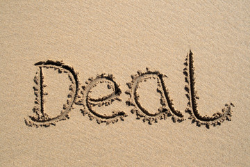 deal, written on a sandy beach