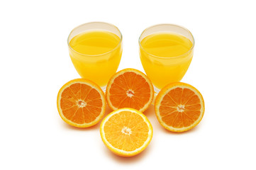 half cut oranges and orange juice isolated on white