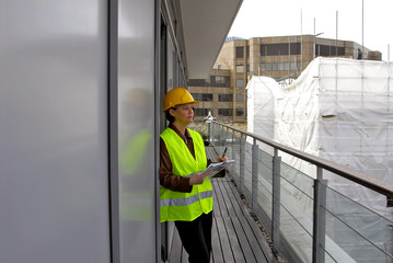 Woman on balcony. Concept for architect, planner, surveyor and reporting.