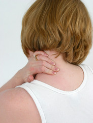 woman holding a sore muscle in neck