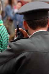 policeman with the radio in the crowd