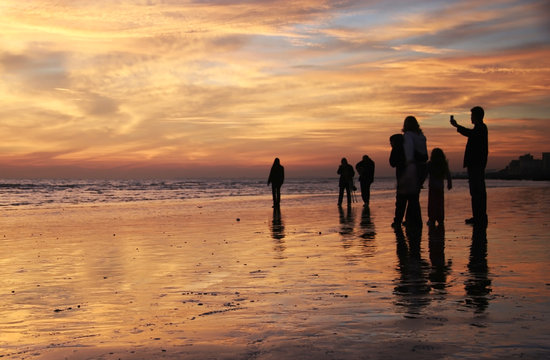 family sunset beach walk