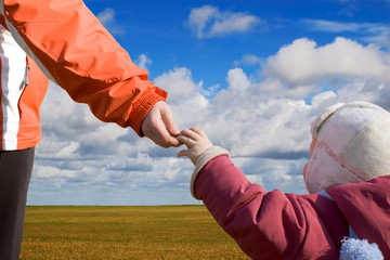 mother and child under blue skies
