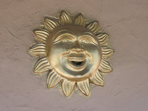 painted gold sun face