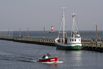 two fishing boats by a pier