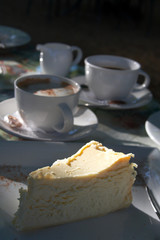 slice of baked cheesecake and coffee.