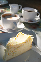 cups of coffe with baked lemon cheesecake.
