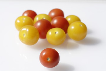 red and yellow tomates on the white