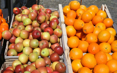apples and oranges outside a british grocery shop.