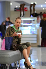 girl is examining the bill in shopping mall