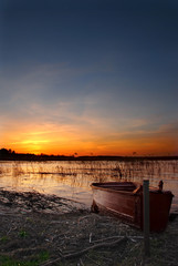 Fototapeta na wymiar a boat by the lake at sunset