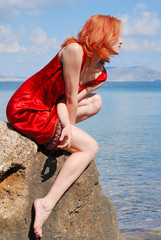 beautiful girl sitting on the rock