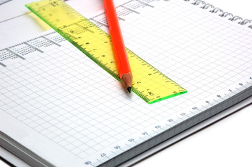 notebook and orange pencil