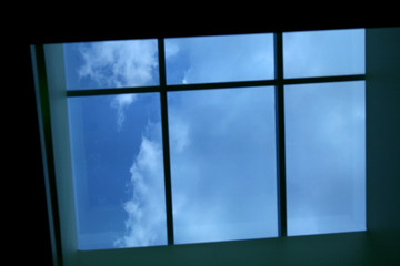 looking up at the sky and clouds through skylight